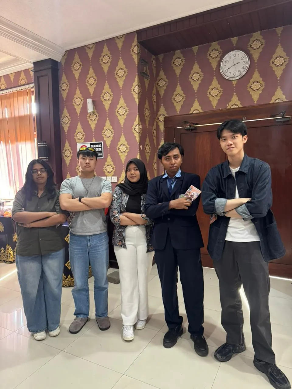 The team standing together with the teaching assistant at the end of a session