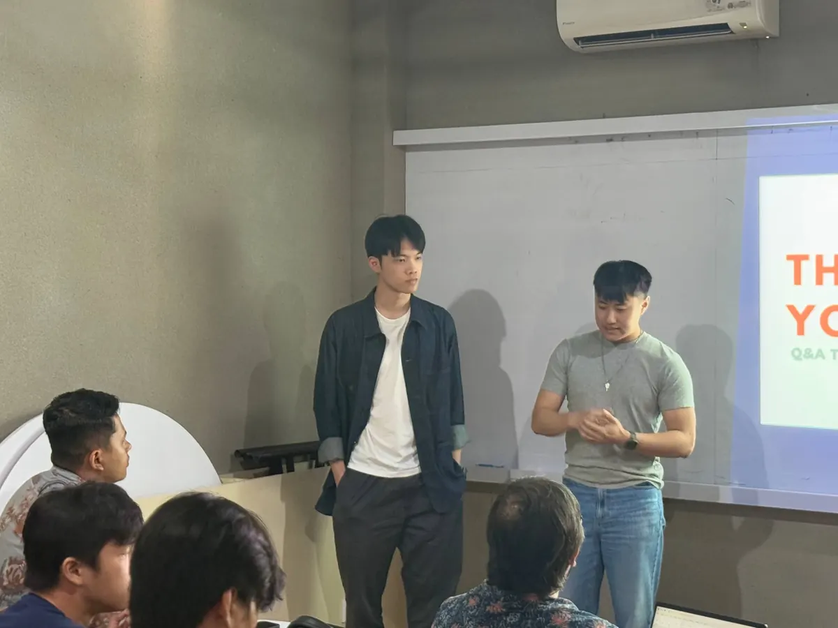 Two of the team standing at the front of the room during a working session