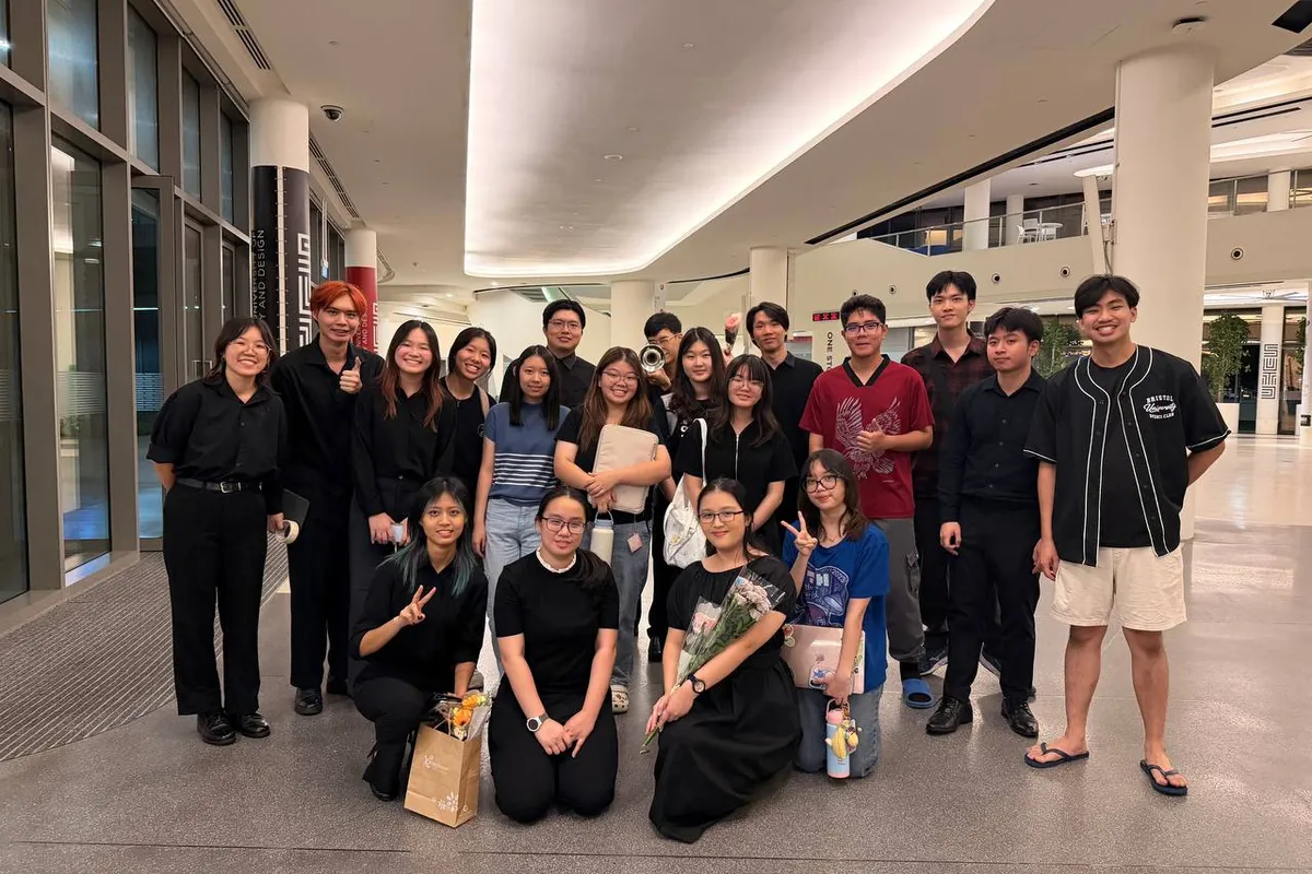 The SUTD Chinese Orchestra together in performance blacks after a concert