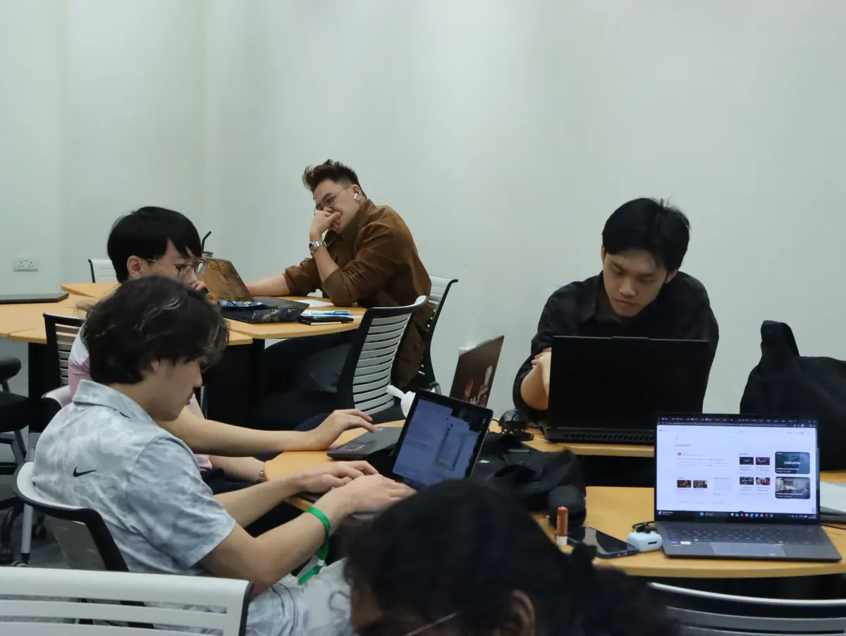 Teams working at laptops in a classroom during the competition