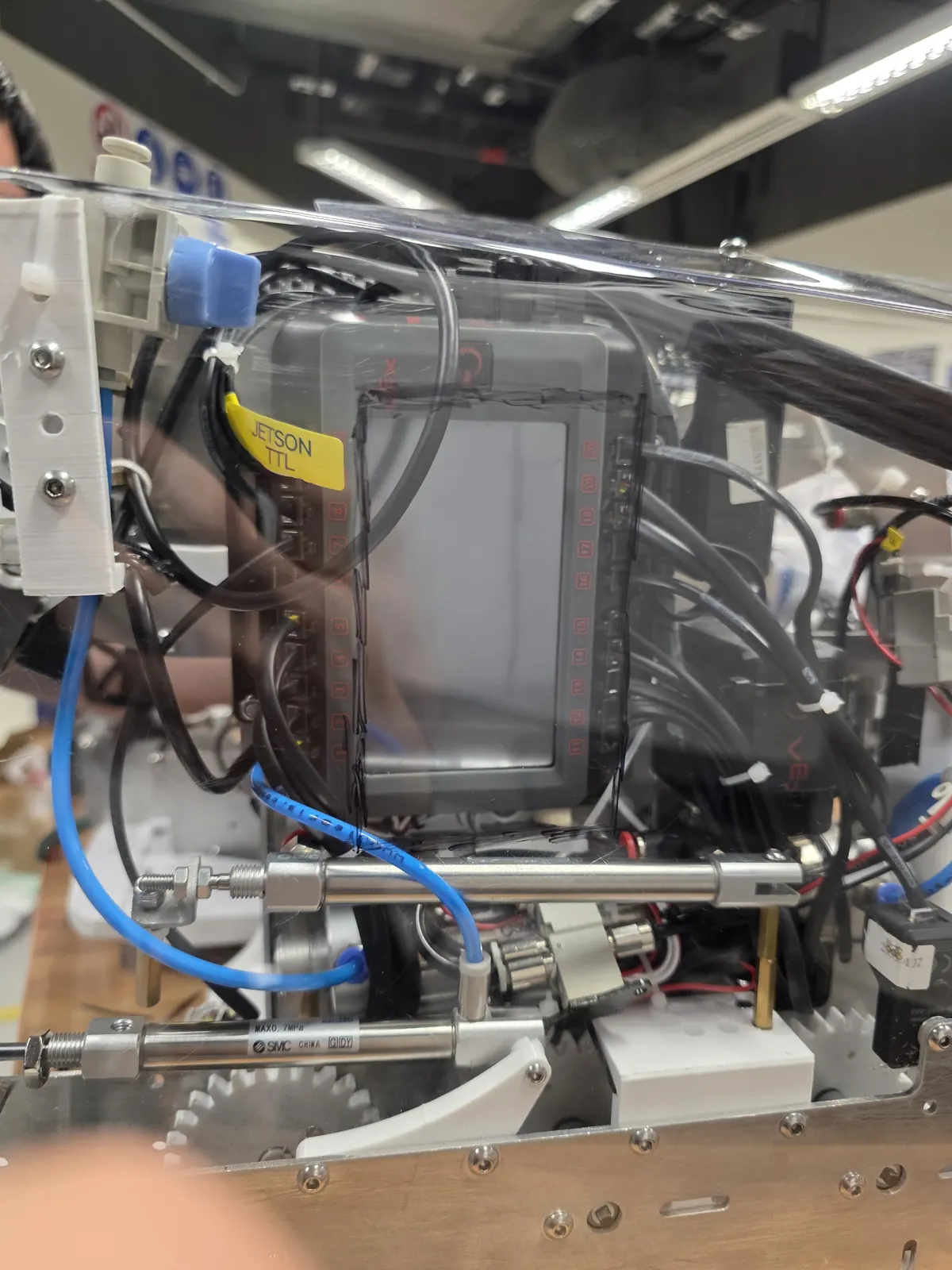 Close view of the robot mechanism with pneumatic cylinders and linkages